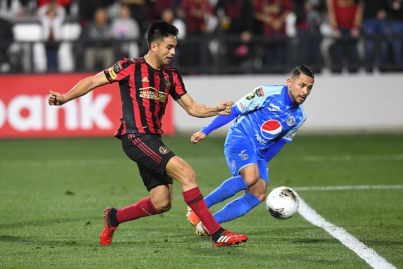 AP photo by John Amis / Atlanta United FC's Pity Martinez, left, scores alongside Motagua's Omar Elvir during the second half of a CONCACAF Champions League quarterfinal Tuesday night at Fifth Third Bank Stadium in Kennesaw, Ga.