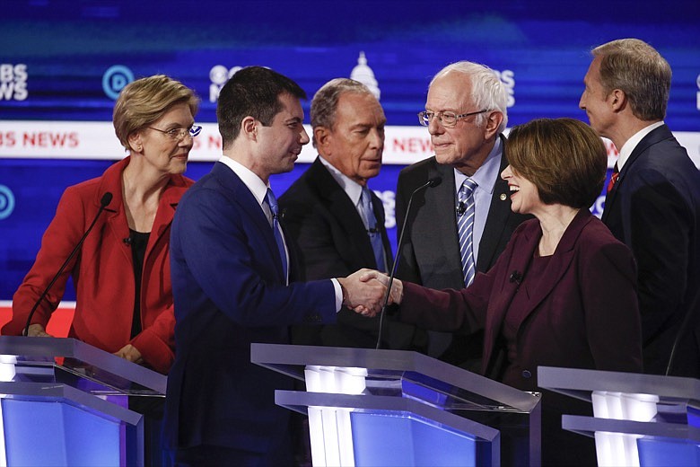 From left, Democratic presidential candidates, Sen. Elizabeth Warren, D-Mass., former South Bend Mayor Pete Buttigieg, former New York City Mayor Mike Bloomberg, Sen. Bernie Sanders, I-Vt., Sen. Amy Klobuchar, D-Minn., and businessman Tom Steyer, greet on another on stage at the end of the Democratic presidential primary debate at the Gaillard Center, Tuesday, Feb. 25, 2020, in Charleston, S.C., co-hosted by CBS News and the Congressional Black Caucus Institute. (AP Photo/Patrick Semansky)