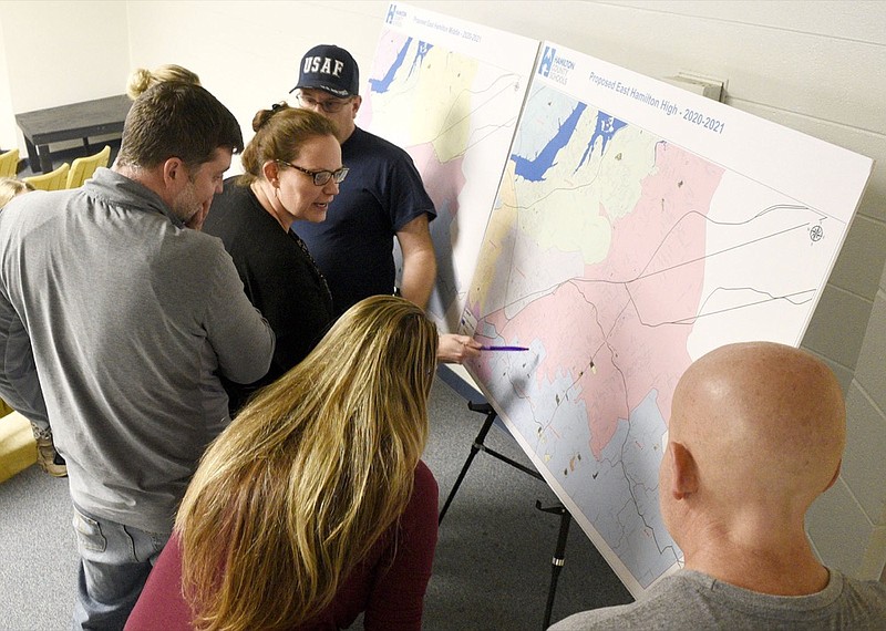 Staff Photo by Robin Rudd/ Arielle Stephens, center, points to a area of concern while other people look at the maps detailing the proposed re-zoning. The conversation about rezoning some of Hamilton County Schools' attendance zones began with a meeting to discuss the East Hamilton/Ooltewah rezoning at Ooltewah Middle School on Tuesday, Jan. 14, 2020.