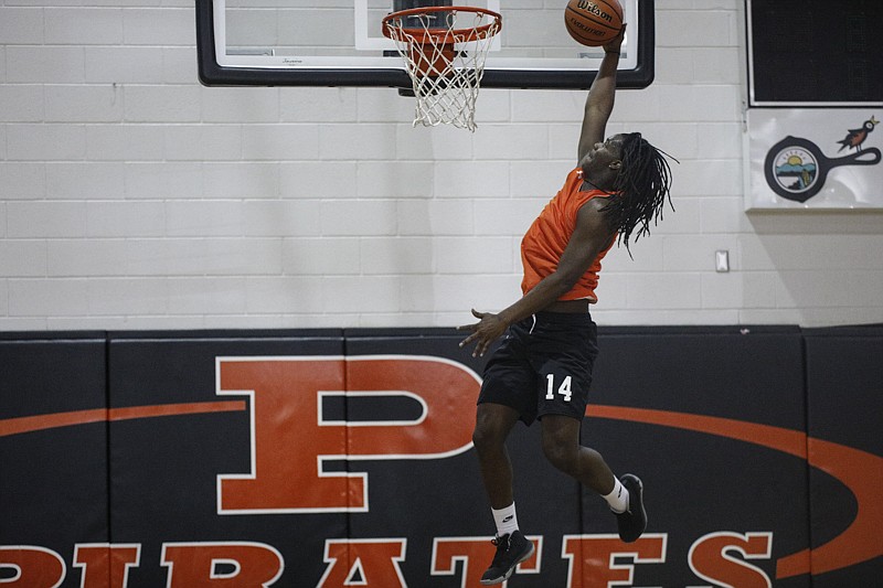 Staff photo by Troy Stolt / South Pittsburg sophomore forward Reggie Hunter dunks during practice Thursday. The Pirates won District 5-A this week to earn their first district tournament title in 34 years.