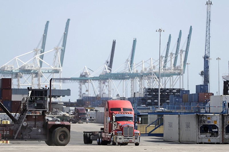 In this Friday, Feb. 14, 2020 photo, a truck leaves the docks at PortMiami in Miami. On Thursday, Feb. 27, the Commerce Department issues the second estimate of how the U.S. economy performed in the fourth quarter. (AP Photo/Wilfredo Lee)