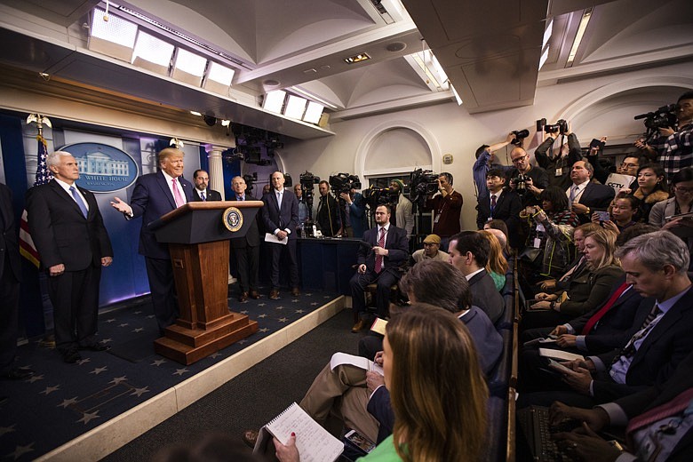 President Donald Trump with Vice President Mike Pence, left, and members of the president's coronavirus task force speaks during a news conference at the Brady press briefing room of the White House, Wednesday, Feb. 26, 2020, in Washington. (AP Photo/Manuel Balce Ceneta)