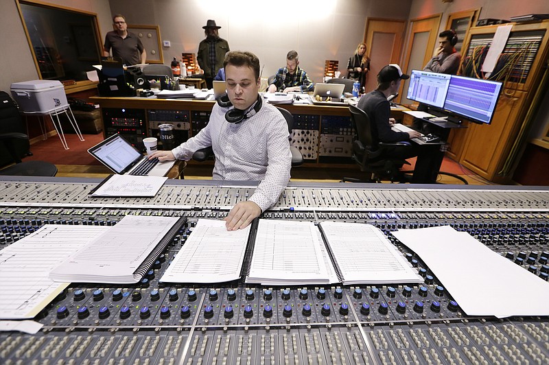 In this Oct. 21, 2019, photo, Nick Spezia works in the control room during the recording of a video game soundtrack in Nashville, Tenn. Music City is earning a new reputation as Soundtrack City. And more production companies, including Netflix, Showtime, Sony and Focus Features, have been lured to Nashville to record music for movies, TV and video games in the last year thanks to a new incentive program. (AP Photo/Mark Humphrey)
