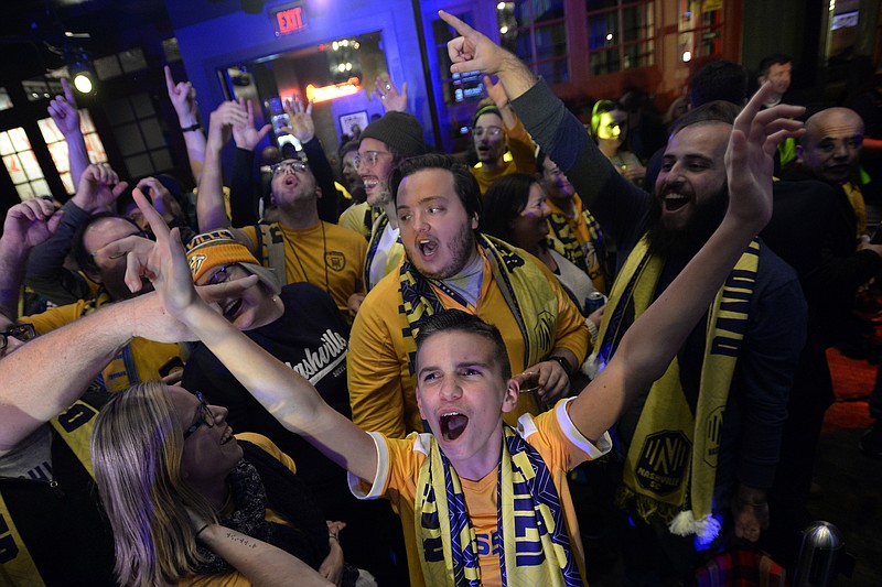 AP photo by Mark Zaleski / Nashville SC fans cheer after the completion of their team's player selections in the MLS expansion draft on Nov. 19, 2019, in Nashville.