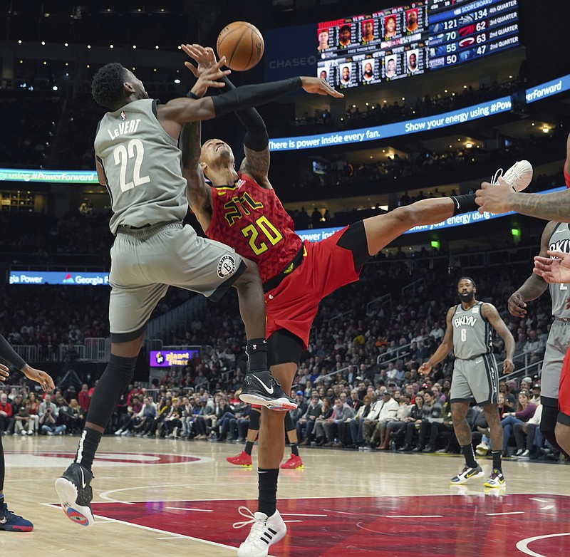 AP photo by Tami Chappell / The Brooklyn Nets' Caris LeVert battles for the ball with the Atlanta Hawks' John Collins in the second half of Friday night's game in Atlanta.