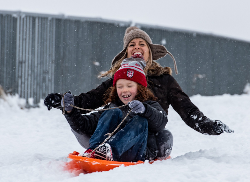 Photo by Cade Deakin/ Rebakah Dance gives her neighbor EJ Wright, 8, a sled ride down a hill at Renaissance Park. Chattanooga and the surrounding areas experienced 2-5f snow overnight according to WRCBtv on Saturday Feb 8, 2020.