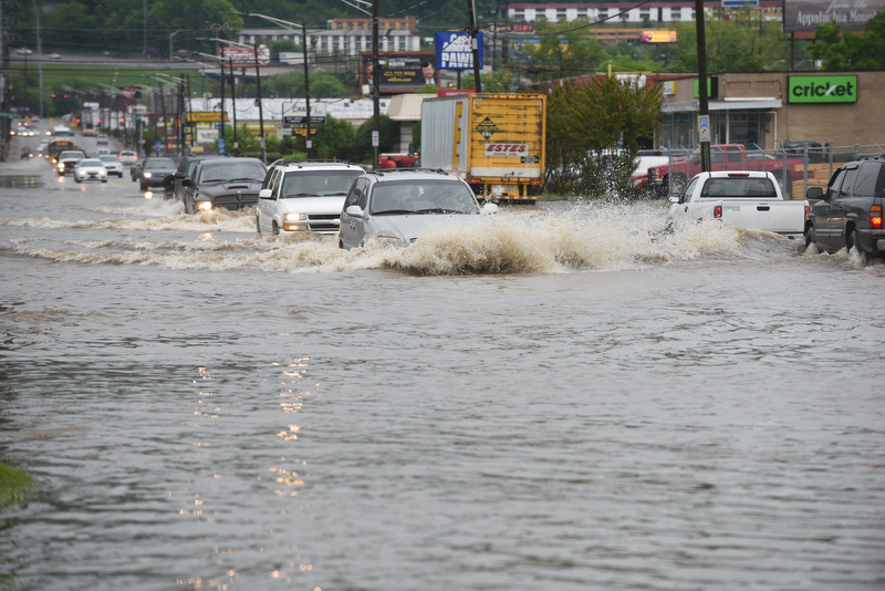 Staff Photo by Angela Lewis Foster/ The Chattanooga Times Free Press- 4/16/15. Cars make their way through flood water on 23rd Street Thursday after heavy rains moved through the Chattanooga area.