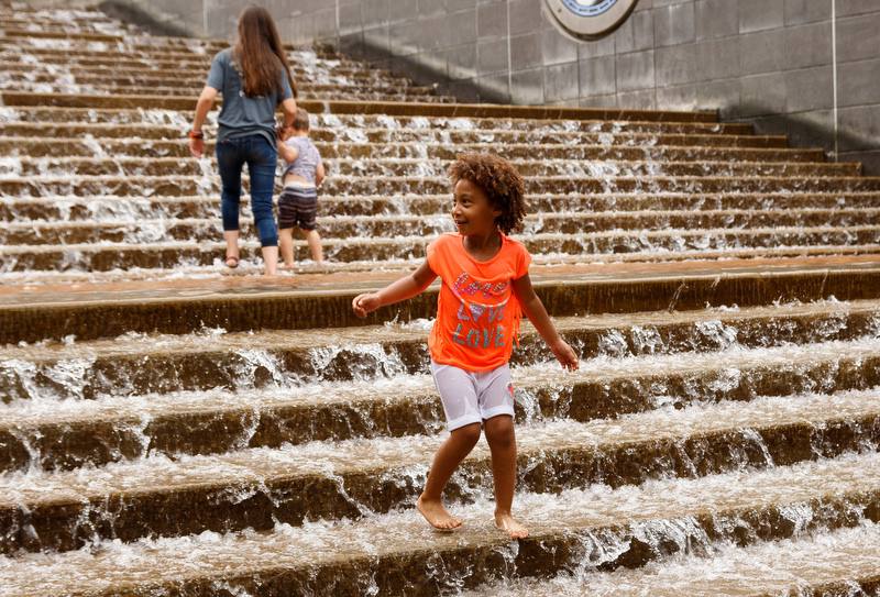Staff photo by Doug Strickland / Melanie Cortes plays in the water at The Passage at Ross's Landing on Thursday, July 18, 2019, in Chattanooga, Tenn. Temperatures Friday are expected to climb into the 90s.