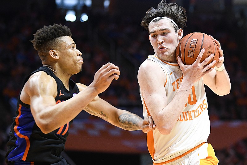 AP photo by Calvin Mattheis / Tennessee junior forward John Fulkerson drives past Florida forward Keyontae Johnson during Saturday's game in Knoxville. Fulkerson scored 22 points and made the first 3-pointer of his Tennessee career to help the Vols beat the Gators 63-58.