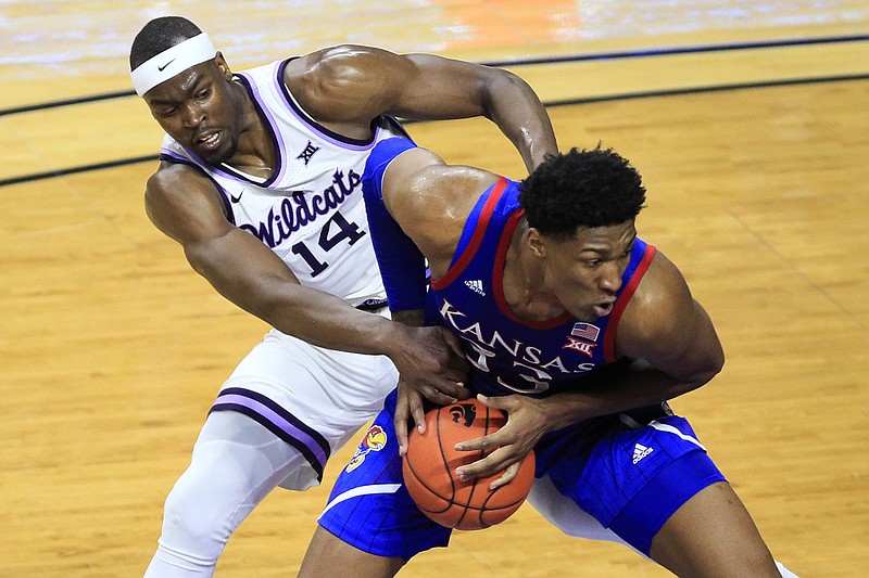 AP photo by Orlin Wagner / Kansas forward David McCormack, with ball, is fouled by Kansas State's Makol Mawien during the second half of Saturday's game in Manhattan, Kan.