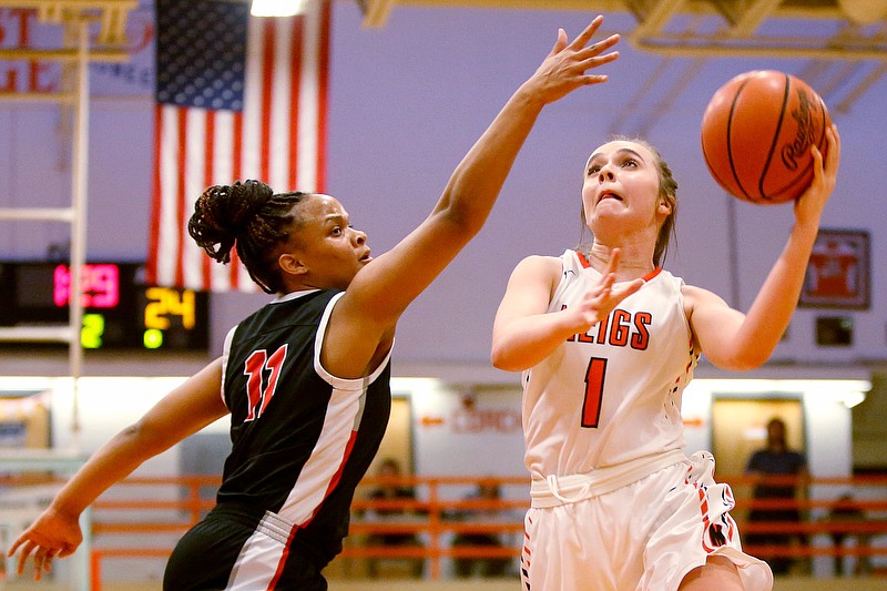 Staff photo by C.B. Schmelter / Meigs County's Anna Crowder (1) puts up a shot against Signal Mountain's Jaylah Hardy (11) during the Region 3-AA semifinals at East Ridge High School's Coach Catherine Neely Gymnasium on Monday, March 2, 2020 in East Ridge, Tenn.