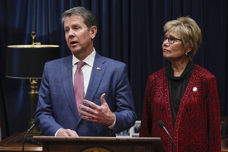Georgia Governor Brian Kemp and Georgia Department of Public Health Commissioner, Dr. Kathleen Toomey, hold a media briefing Friday, Feb. 28, 2020, in Atlanta, regarding the creation of the Governor's Coronavirus Task Force. (Bob Andres/Atlanta Journal-Constitution via AP)