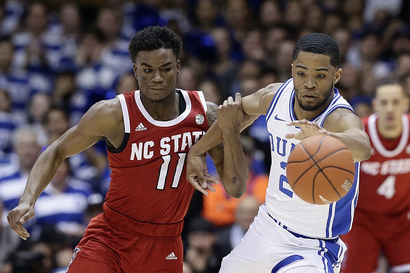 North Carolina State guard Markell Johnson (11) and Duke guard Cassius Stanley (2) chase the ball during the first half of an NCAA college basketball game in Durham, N.C., Monday, March 2, 2020. (AP Photo/Gerry Broome)