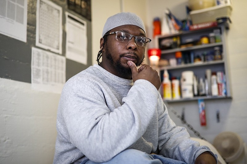 In this Feb. 13, 2020, photo, inmate Myon Burrell sits inside his cell at Minnesota Correctional Facility in Stillwater, Minn. Sentenced to life after a young black girl was killed by a stray bullet, Burrell's story has been told - and told again - by U.S. Sen. Amy Klobuchar while trumpeting her tough-on-crime record as a top Minneapolis prosecutor. But a year-long Associated Press investigation discovered major flaws and inconsistencies in the case, raising questions about whether the 16-year-old alleged shooter may have been wrongly convicted. (AP Photo/John Minchillo)