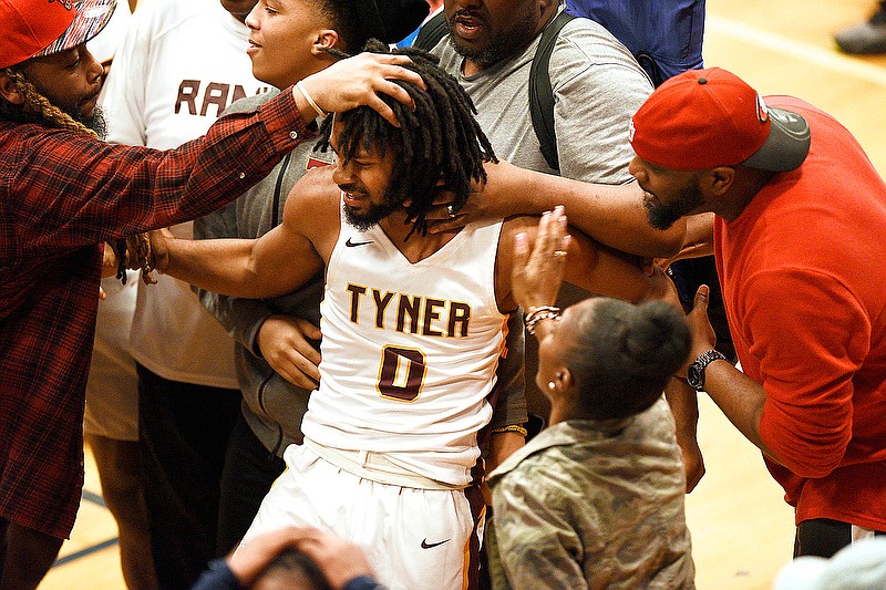 Staff Photo by Robin Rudd / Tyner's Melique Hambrick (0) is congratulated by the crowd after making a last second three-point shot to win the game 53-52 over Red Bank.  The Red Bank Lions faced the Tyner Rams in the semifinal game of the 3-AA basketball tournament at East Ridge High School on March 3, 2020. 