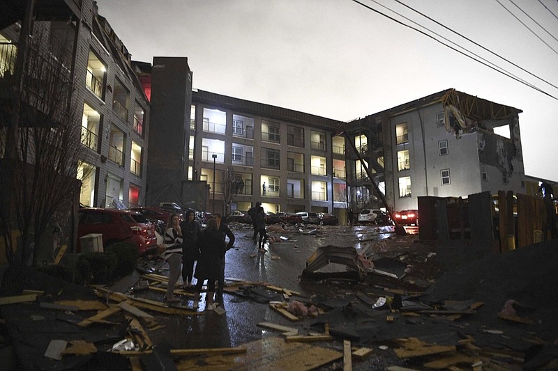 Debris is scattered across the parking lot of a damaged apartment building after a tornado hit Nashville in the early morning hours of Tuesday, March 3, 2020. (Courtney Pedroza/The Tennessean via AP)