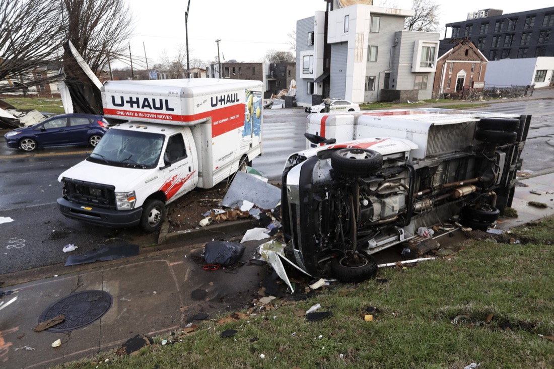 Damaged trucks sit on a sidewalk as well as the street following a deadly tornado, Tuesday, March 3, 2020, in Nashville, Tenn. Tornadoes ripped across Tennessee early Tuesday, shredding buildings and killing multiple people. (AP Photo/Mark Humphrey)