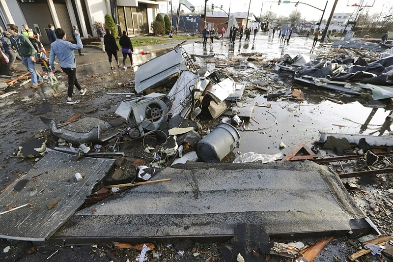 Debris covers a street after overnight storms Tuesday, March 3, 2020, in Nashville, Tenn. Tornadoes ripped across Tennessee early Tuesday, shredding buildings and killing multiple people. (AP Photo/Mark Humphrey)