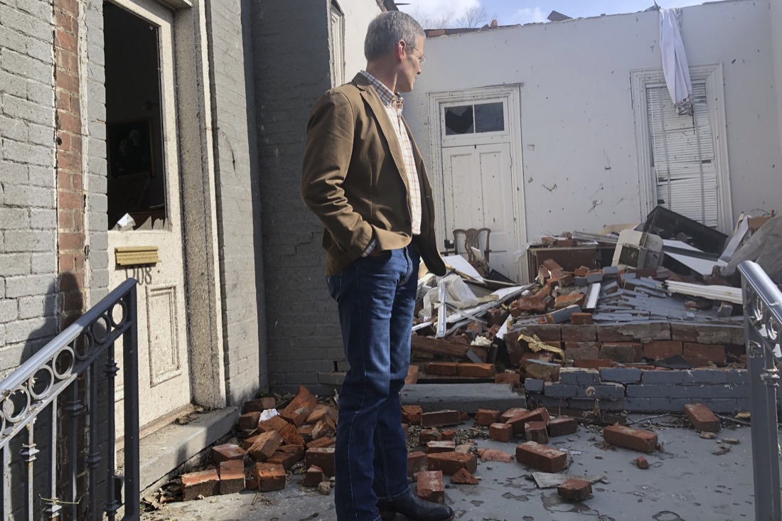 Tennessee Gov. Bill Lee surveys damage to buildings in Nashville, Tenn. on Tuesday, March 3, 2020. Tornadoes ripped across Tennessee early Tuesday, shredding at least 40 buildings and killing many people. One of the twisters caused severe damage across downtown Nashville, destroying the stained glass in a historic church and leaving hundreds of people homeless. (AP Photo/Travis Loller)