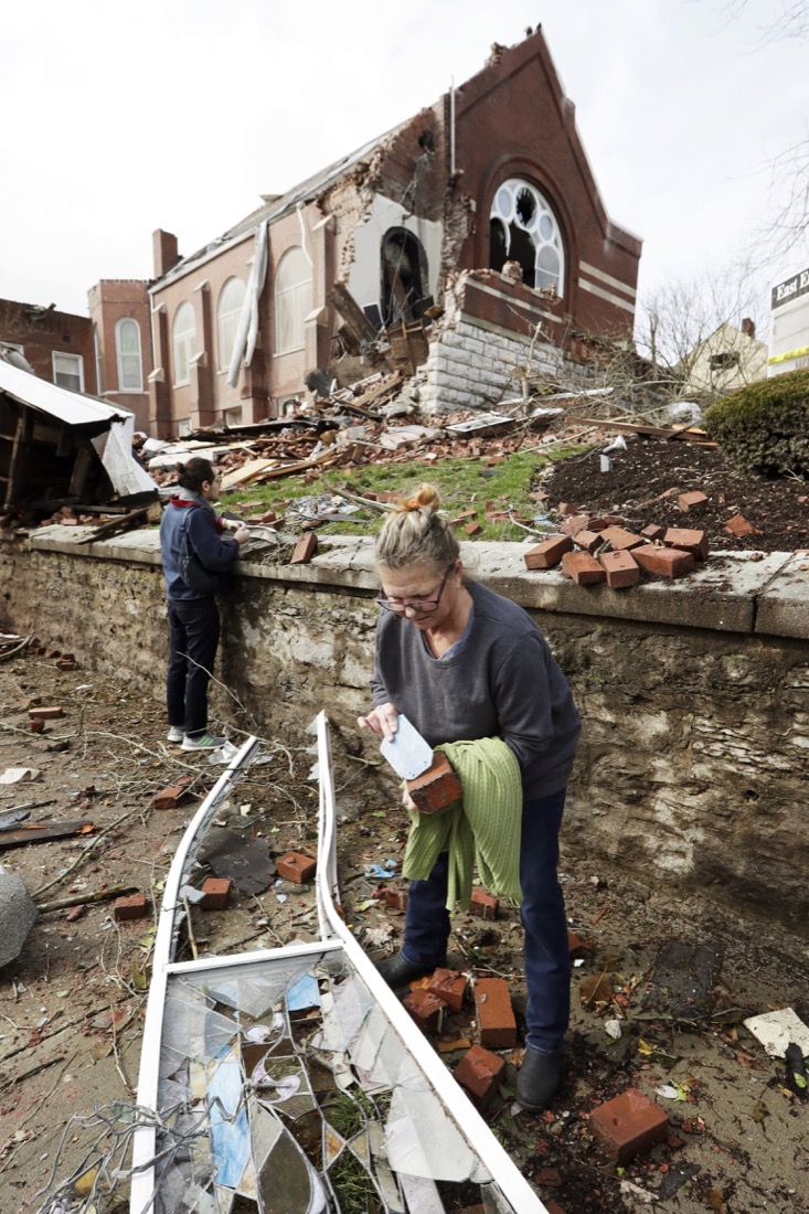 Sumant Joshi helps to clean up rubble at the East End United Methodist Church after it was heavily damaged by storms Tuesday, March 3, 2020, in Nashville, Tenn. Joshi is a resident in the area and volunteered to help clean up. Tornadoes ripped across Tennessee early Tuesday, shredding buildings and killing multiple people. (AP Photo/Mark Humphrey)