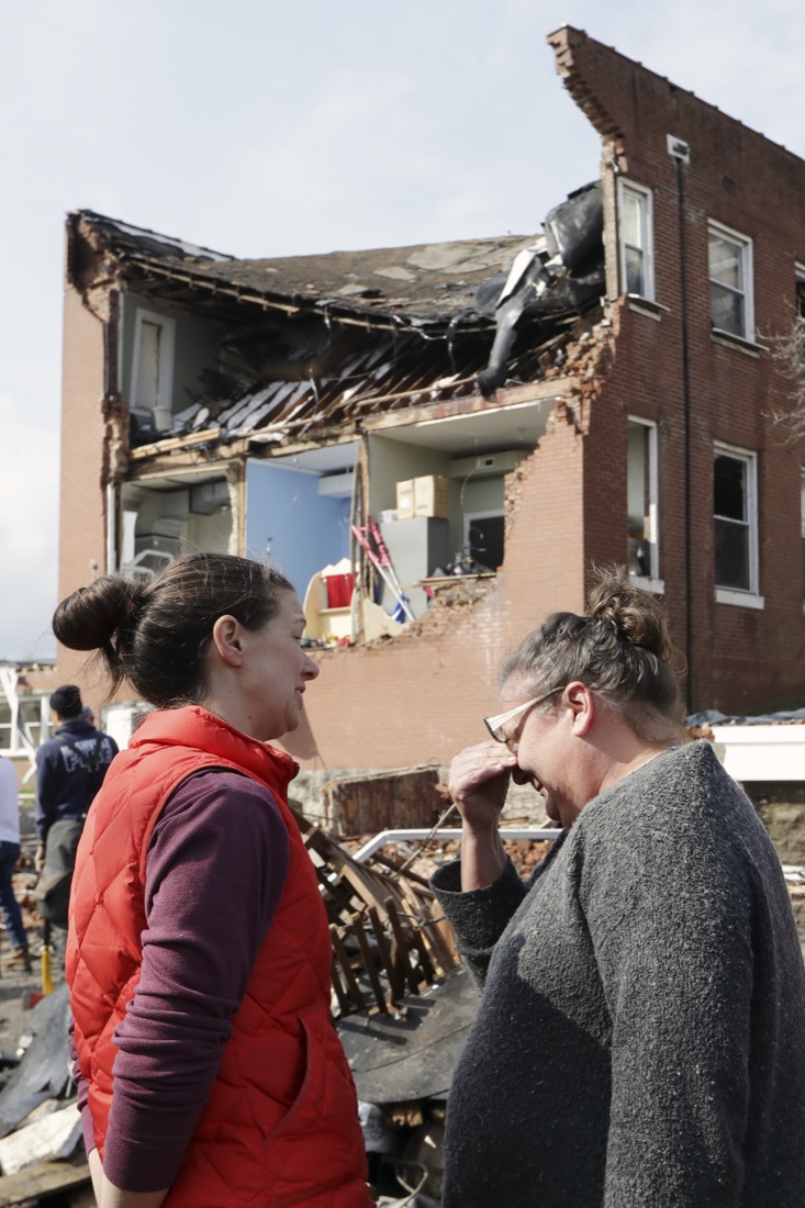 Debbie Jones, right, wipes tears as she views the damage to East End United Methodist Church after it was heavily damaged by a storm Tuesday, March 3, 2020, in Nashville, Tenn. Jones attended the church when she was a child. Tornadoes ripped across Tennessee early Tuesday, shredding buildings and killing multiple people. (AP Photo/Mark Humphrey)