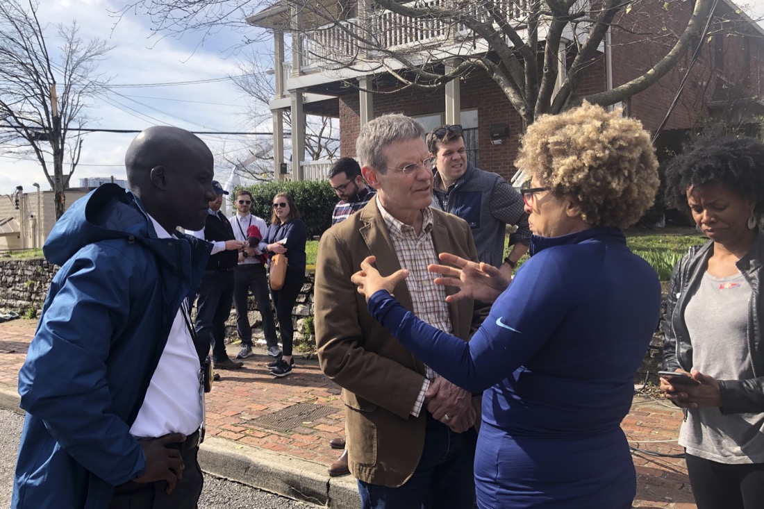 Tennessee Gov. Bill Lee speaks with business owner Mignon Francois, in Nashville, Tenn. on Tuesday, March 3, 2020. Tornadoes ripped across Tennessee early Tuesday, shredding at least 40 buildings and killing many people. One of the twisters caused severe damage across downtown Nashville and leaving hundreds of people homeless. (AP Photo/Travis Loller)