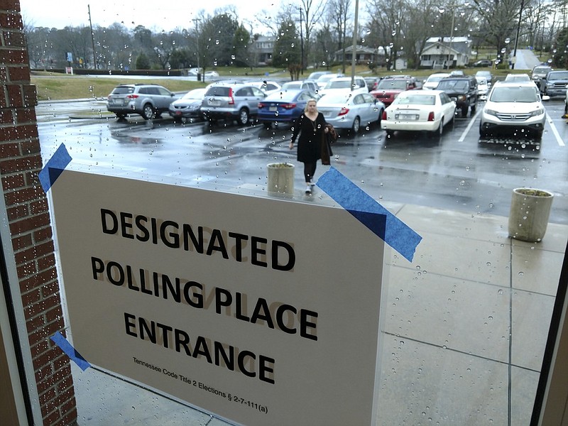 Staff photo by Ben Benton / Voter April Prestwood makes her way through a steady rain to the voting precinct at the Brainerd BX Tuesday morning.