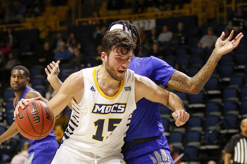 Staff photo by C.B. Schmelter / UTC forward Ramon Vila drives past Tennessee State's Shakem Johnson during a home game on Nov. 9, 2019.