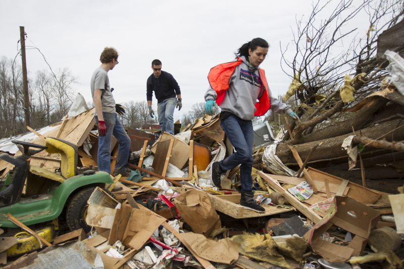 Staff photo by Troy Stolt / Volunteers Ciara Badavs, left, Ben Mann, center, and Paxton Phifer, right, sift through wreckage at the house of the late Jessica Clark in Cookeville, Tenn on Wednesday, March 4, 2020. A tornado destroyed 140 buildings in Putnam County, killing at least 18 people early Tuesday, Clark was one of those who was killed.