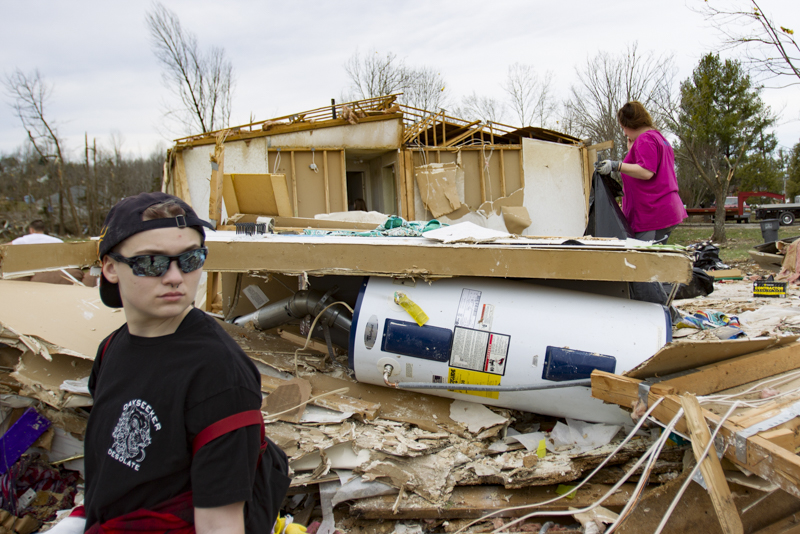 Staff photo by Troy Stolt / Tn Tech student Carli Williams, left, looks around Debra Maxwell's front yard in Cookeville, Tenn on Wednesday, March 4, 2020. A tornado destroyed 140 buildings in Putnam County early Tuesday, killing at least 18 people, and leaving many without homes.