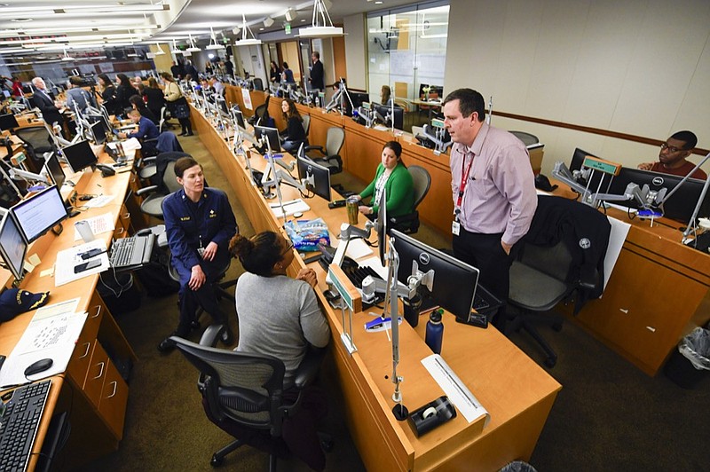 Personnel at the The Centers for Disease Control and Prevention (CDC) work the Emergency Operations Center in response to the 2019 Novel Coronavirus, among other things, Thursday, Feb. 13, 2020, in Atlanta. (AP Photo/John Amis)


