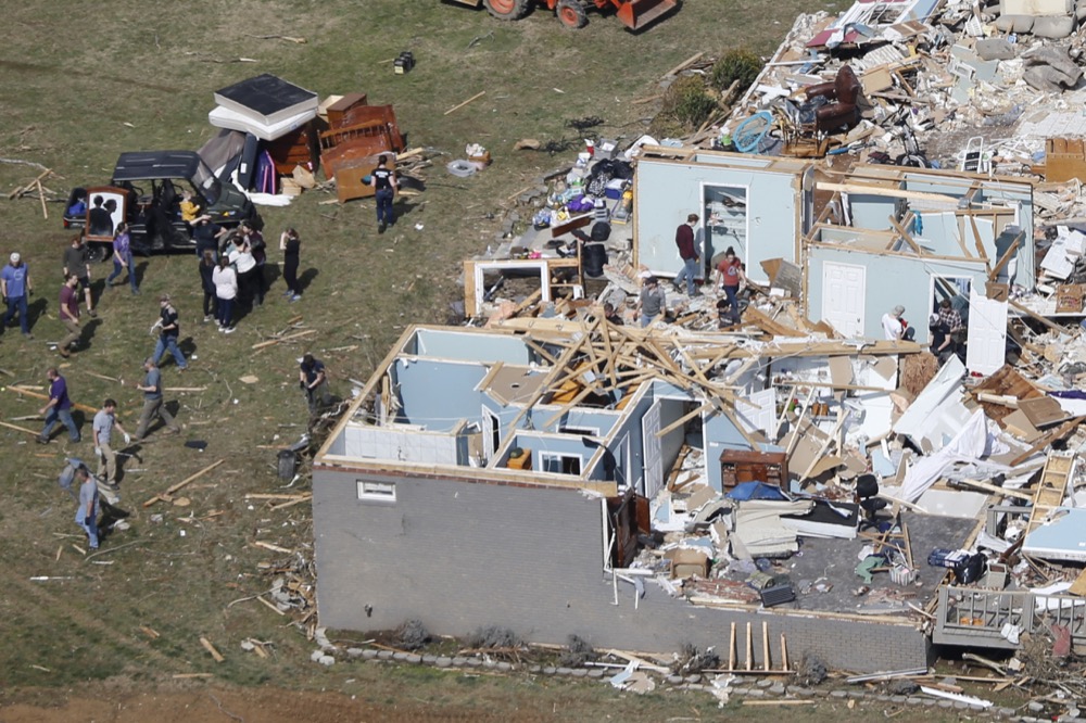 People work to salvage items Tuesday, March 3, 2020, near Cookeville, Tenn. Tornadoes ripped across Tennessee early Tuesday, shredding more than 140 buildings and burying people in piles of rubble and wrecked basements. (AP Photo/Mark Humphrey)
