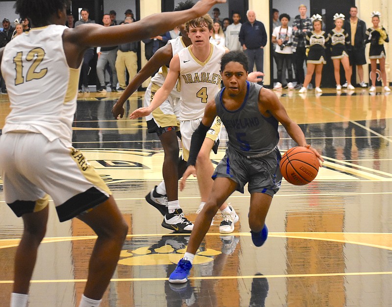 Staff photo by Patrick MacCoon / Cleveland senior Antonio Whaley drives past Bradley Central defenders during the Region 3-AAA championship game Thursday night at Bradley Central.