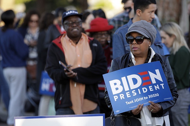 People wait to attend a campaign rally for Democratic presidential candidate former Vice President Joe Biden on Tuesday, March 3, 2020, in Los Angeles. (AP Photo/Marcio Jose Sanchez)
