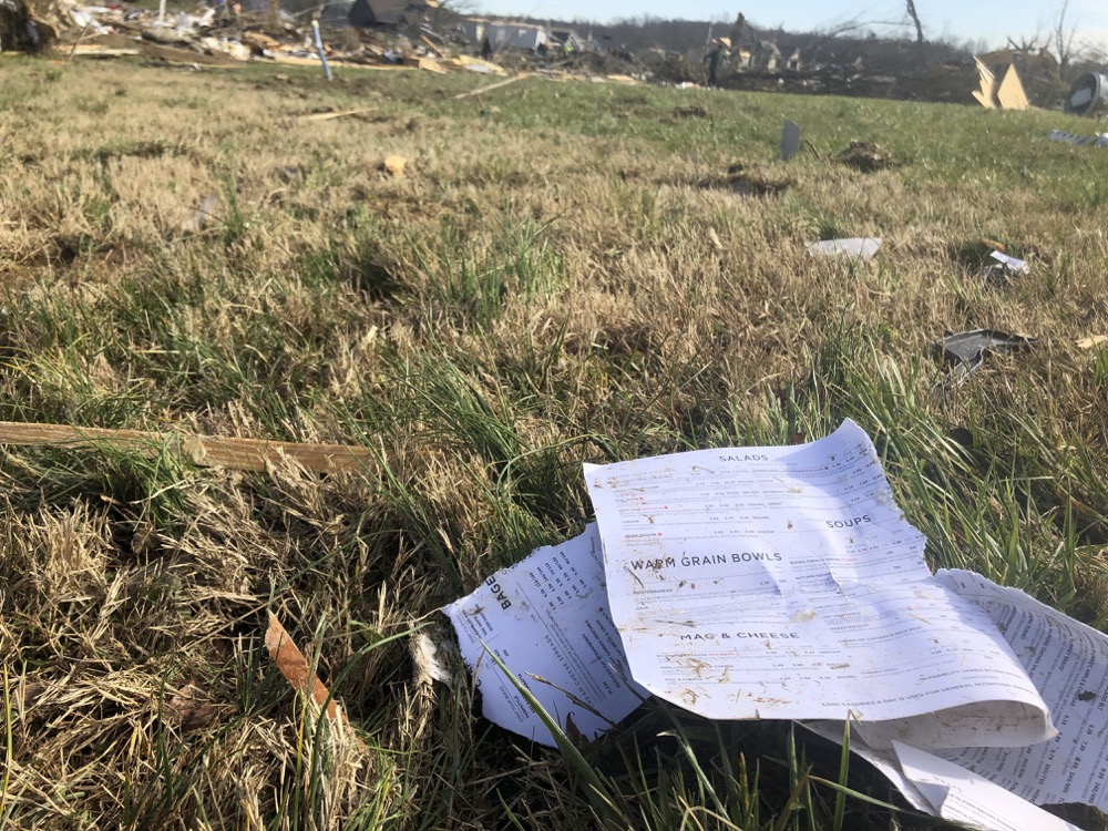 Pages from a recipe book lie in a yard Wednesday after a tornado destroyed much of a subdivision near McBroom Chapel Road in Putnam County, Tennessee, before dawn on Tuesday, March 3, 2020. (AP Photo/Travis Loller)