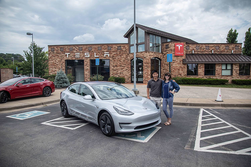 Ji Hoon Heo, left, CEO of TeslaBros, a company that makes Tesla accessories, is pictured with his wife, Annalee at a Tesla delivery center in Brentwood, Tenn. / Photo Contributed photo by TeslaBros.