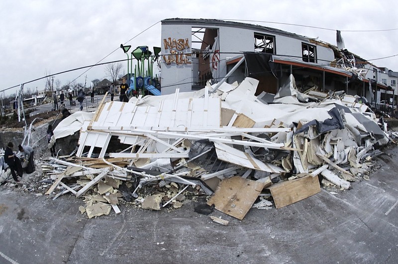 Debris is piled up by a damaged business Wednesday, March 4, 2020, in Nashville, Tenn. Residents and businesses face a huge cleanup effort after tornadoes hit the state Tuesday, killing at least 24 people and leaving many others missing. (AP Photo/Mark Humphrey)


