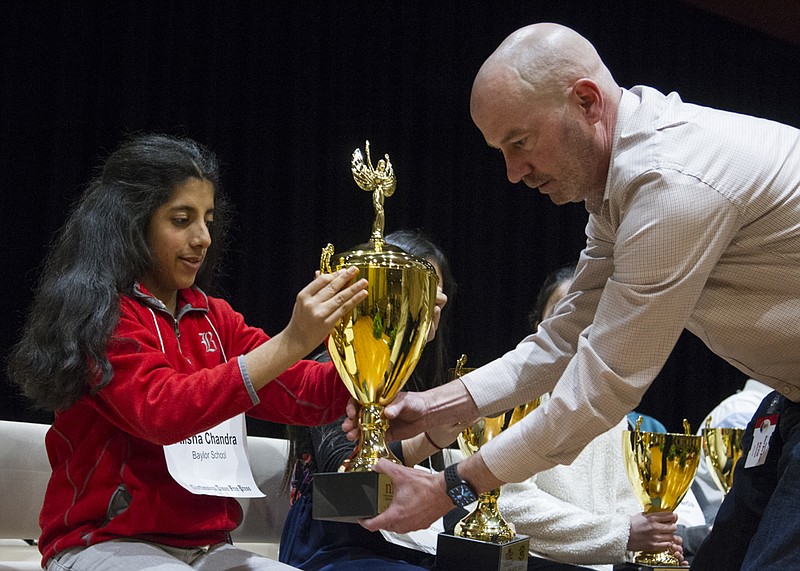 Staff photo by Troy Stolt / Alisha Chandra is presented with her first place trophy after winning the Times Free Press Regional Spelling Bee at the University Center auditorium on campus at UTC on Saturday, March 7, 2020 in Chattanooga, Tenn.