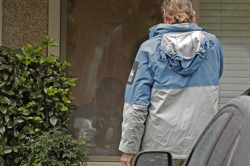 Gene Campbell, left, watches through his window as he talks on the phone with his son Charlie at the Life Care Center in Kirkland, Wash., Friday, March 6, 2020. Charlie and his mother Dorothy came to visit Gene Friday as he is isolated in the facility that has been the epicenter of the outbreak of the the COVID-19 coronavirus. Charlie later told reporters that his father, who had not yet been tested, was showing symptoms of the virus and would be taken to a hospital. (AP Photo/Ted S. Warren)


