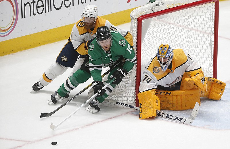 AP photo by Ron Jenkins / Dallas Stars center Joe Pavelski, in green, controls the puck as Nashville Predators defenseman Ryan Ellis, rear, and goaltender Juuse Saros work to protect the net during Saturday's game in Dallas. Nashville won 1-0.