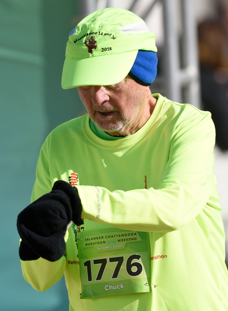 Staff Photo by Robin Rudd / Chuck Van Duzee checks his time as he finishes the half marathon. The 5th Erlanger Chattanooga Marathon was run on March 8, 2020.