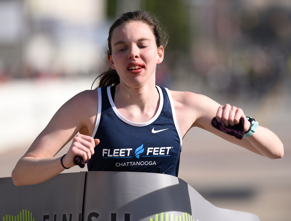 Staff Photo by Robin Rudd / Female winner Margaret Fitch crosses the finish line with a time of 3:28:08. The 5th Erlanger Chattanooga Marathon was run on March 8, 2020.