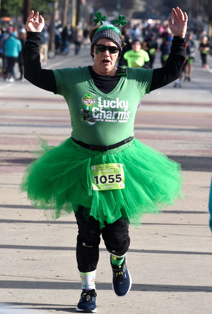 Staff Photo by Robin Rudd / Dressed in Lucky Charm attire Joanne Blatchley finishes the half marathon. The 5th Erlanger Chattanooga Marathon was run on March 8, 2020.