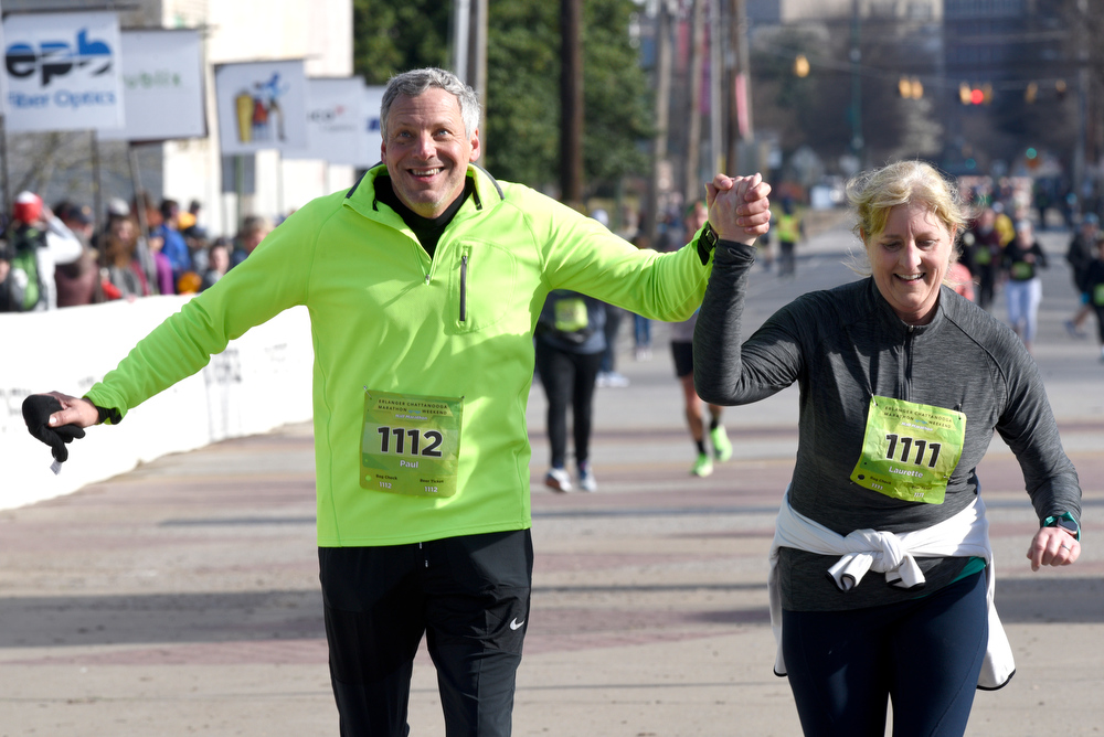Staff Photo by Robin Rudd / Paul and Laurette Calkins cross the finish line in the half marathon together. The 5th Erlanger Chattanooga Marathon was run on March 8, 2020.