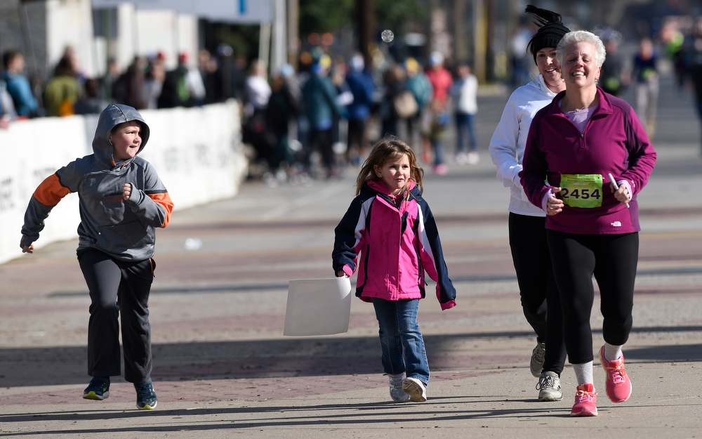 Staff Photo by Robin Rudd / Suzanne Roche-Dalton gets some encouragement at the finish of the half marathon. The 5th Erlanger Chattanooga Marathon was run on March 8, 2020.