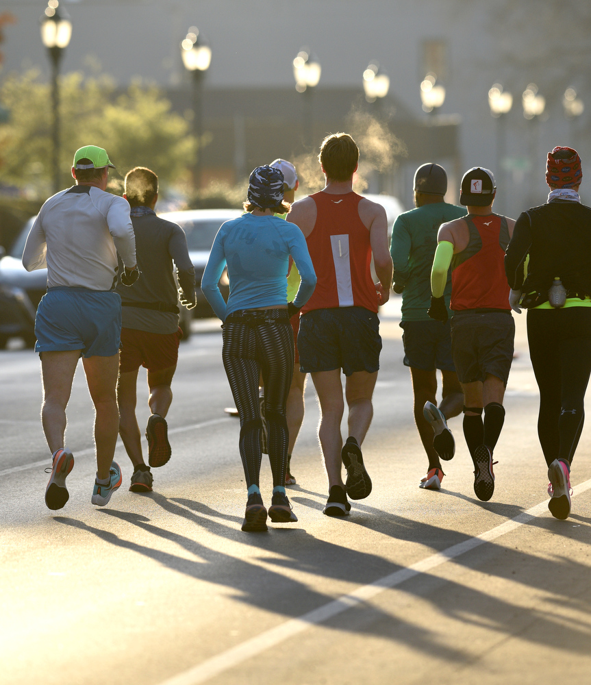 Staff Photo by Robin Rudd / Participants head east, into the rising sun, on Martin Luther King Jr. Blvd. The 5th Erlanger Chattanooga Marathon was run on March 8, 2020.