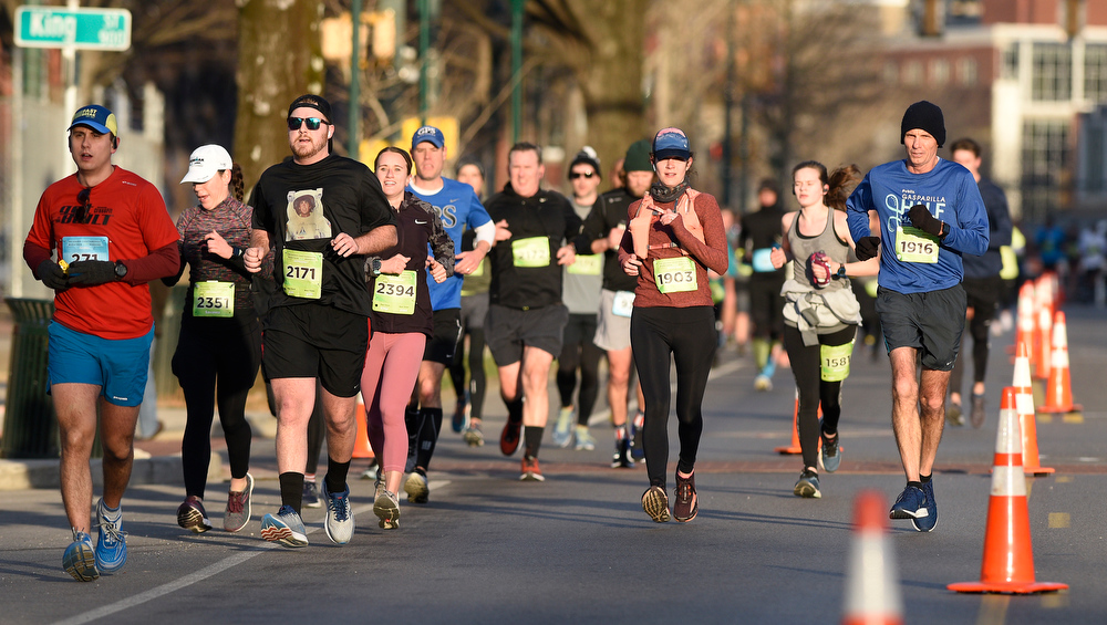 Staff Photo by Robin Rudd / Participants head east, into the rising sun, on Martin Luther King Jr. Blvd. The 5th Erlanger Chattanooga Marathon was run on March 8, 2020.