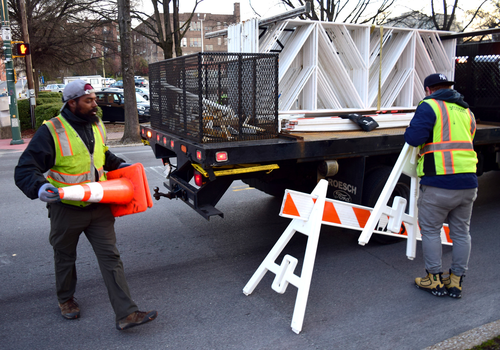 Staff Photo by Robin Rudd / A crew readies the course on Martin Luther King Jr. Blvd. before the runners arrive. The 5th Erlanger Chattanooga Marathon was run on March 8, 2020.