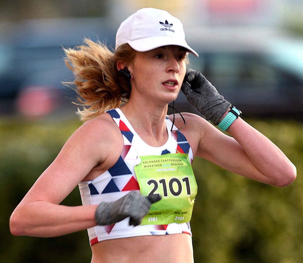 Staff Photo by Robin Rudd / Whitley Waldrop adjusts her headphones as she comes down Lindsey Street. Waldrop would finish second in the half marathon. The 5th Erlanger Chattanooga Marathon was run on March 8, 2020.