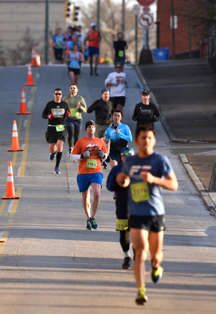 Staff Photo by Robin Rudd / Runners compete on a downhill portion of Lindsey Street. The 5th Erlanger Chattanooga Marathon was run on March 8, 2020.